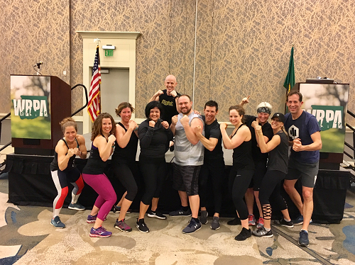 Conference Photo people flexing muscles in workout session group shot